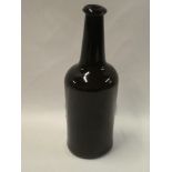 An 18th century hand-blown glass wine bottle,