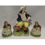 A pair of Staffordshire pottery figures of Red Riding Hood and one other Staffordshire pottery