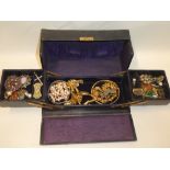 A jewellery box containing a quantity of various costume jewellery including brooches, rings,