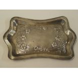 An Edward VII silver rectangular tray decorated in relief with stylised flowers,