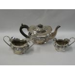 An Edward VII silver oval three-piece tea set comprising teapot with hinged lid,