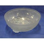 A blue tinted pressed glass circular bowl with raised rose and leaf decoration 8¼" diameter