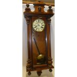 A Vienna-style wall clock with decorated circular dial in walnut rectangular glazed traditional