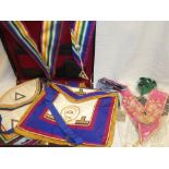 Three cases containing a selection of various Masonic regalia comprising aprons, sashes,