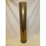 A large brass shell-case 31" long