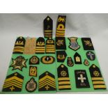 A collection of Naval and Air Force Chaplain's badges and insignia including epaulette's,