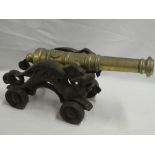 A good quality brass ornamental signal cannon with 15" brass tapered barrel and iron carriage