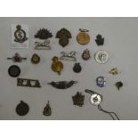 A selection of military badges including Royal Fusiliers, South African Medical Corps,