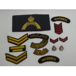 A Second War Civil Defence embroidered arm-band, Cornwall and Devon Civil Defence shoulder titles,
