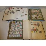 Three folder albums containing a selection of World stamps