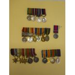 Four miniature medal groups including QSA/KSA with Territorial Decoration,