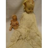 An old composition doll with painted face and jointed body and one other celluloid doll (2)