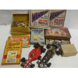 A selection of various vintage jigsaws, two model F1 racing cars etc.