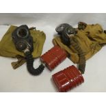 Two Second War British military issue gas masks with carrying bags