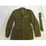 A post-Second War Lieutenant's khaki tunic of the Essex Regiment with bronze collars,