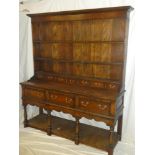 A good quality Georgian-style oak farmhouse dresser with three drawers in the frieze above open pot