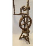 A beech wood traditional spinning wheel with turned supports