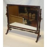 A small mahogany rectangular swing toilet mirror on turned supports