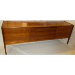 A 1960's teak sideboard by Younger with three central drawers flanked by cupboards enclosed by two
