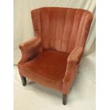 A 1930's wing easy chair with ribbed back on square tapered legs