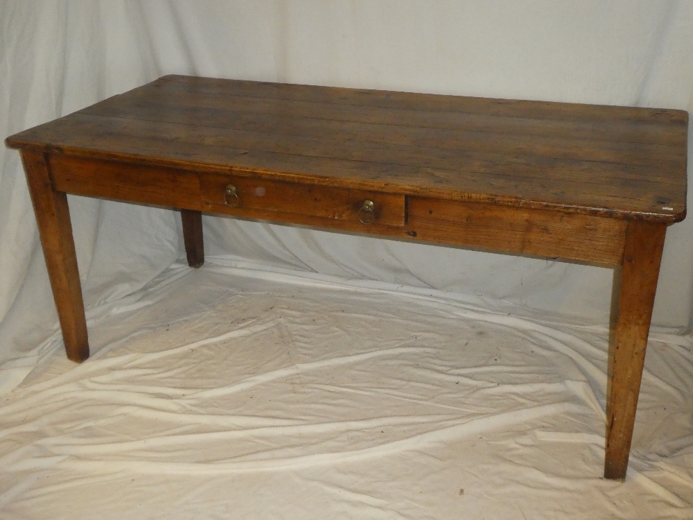 A 19th century polished elm kitchen table with a pull-out slide in one end opposing a single end