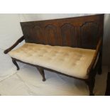 A late 18th/early 19th century oak settle, the back with five arched panels,