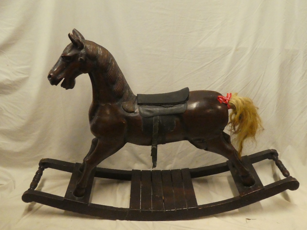 A good quality 20th century carved wood traditional rocking horse with leather saddle,