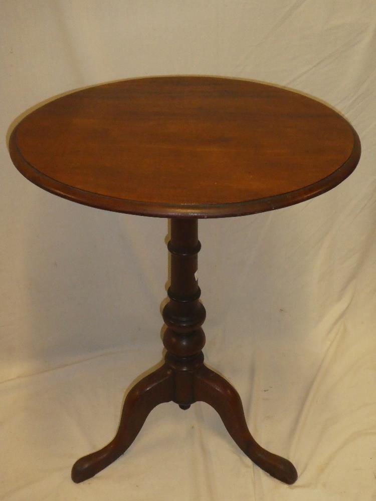 A 19th century mahogany oval occasional table on turned column with tripod base