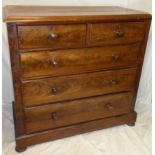 A Victorian figured mahogany chest of two short and three long drawers with turned handles on
