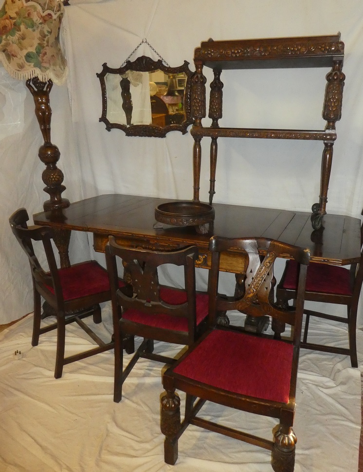 An unusual 1930/40's suite of carved oak matching dining and lounge furniture comprising a