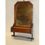 A late Victorian rectangular wall mirror in polished mahogany frame with attached candle box and