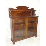 A Victorian figured mahogany chiffonier with adjustable shelves enclosed by two glazed doors below