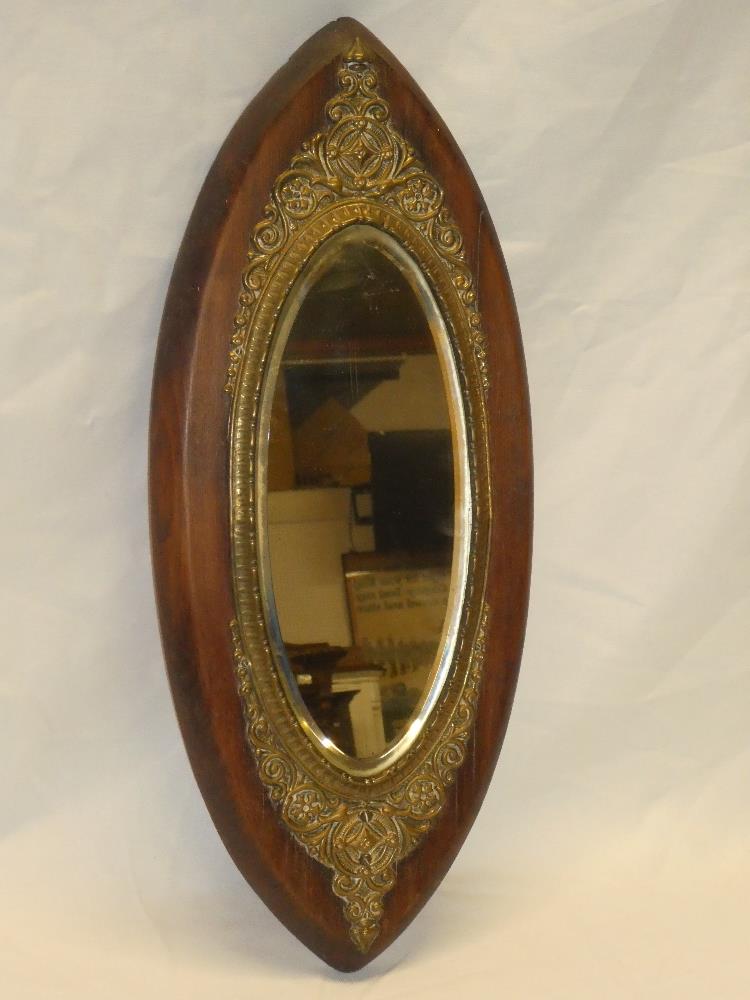 A late Victorian bevelled oval wall mirror in brass mounted mahogany oval frame,