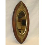 A late Victorian bevelled oval wall mirror in brass mounted mahogany oval frame,