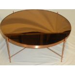 A 1970's aluminium circular coffee table with rose tinted mirrored top,