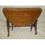 A Victorian mahogany oval Sutherland-style drop leaf tea table on turned fluted supports and scroll