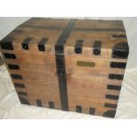 A 19th century metal-bound oak rectangular domed trunk with hinged lid and iron handles,