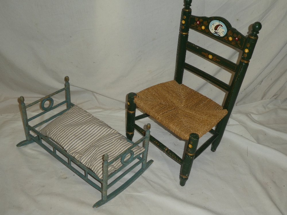 A child's painted wood chair with string work seat and a painted beech wood miniature cot (2)
