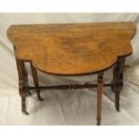 A mid Victorian figured walnut oval Sutherland-style tea table with pierced supports on brass