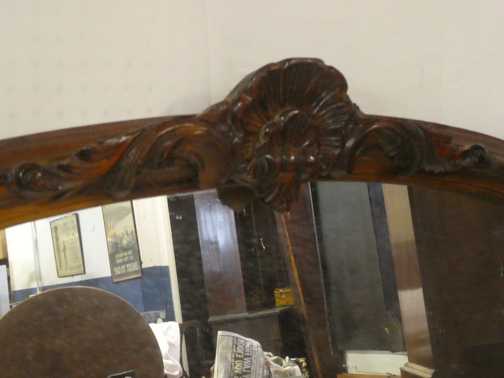 An old arched over-mantel mirror in carved and stained wood frame with scallop mount 56" x 45" - Image 2 of 2