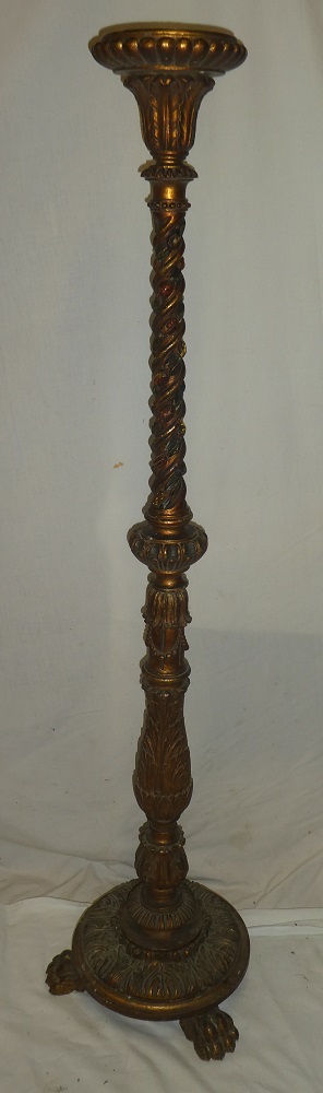 An old gilt painted candle stand/lamp base with raised scroll decoration on circular base with paw