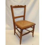 An old beech child's chair with rail back and cane work seat