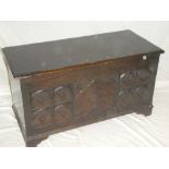 A good quality small carved oak rectangular coffer with decorated front and hinged lid on bracket