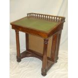 A Victorian rosewood Davenport desk with pigeon holes enclosed by a hinged sloping writing surface,