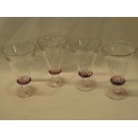 Four art glass tapered goblets with amethyst tinted stems, indistinctly signed,