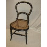 A Victorian ebonised occasional chair inlaid with mother of pearl floral designs,