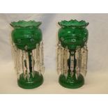 A pair of green tinted glass table lustres with painted floral decoration and glass lozenge