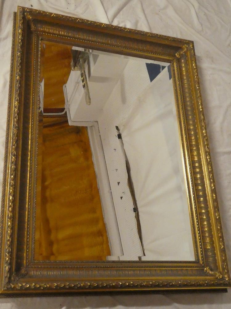A good quality bevelled rectangular wall mirror in ornate gilt frame,