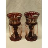 A pair of 20th century ruby-tinted glass table lustres with etched deer and foliage decoration with