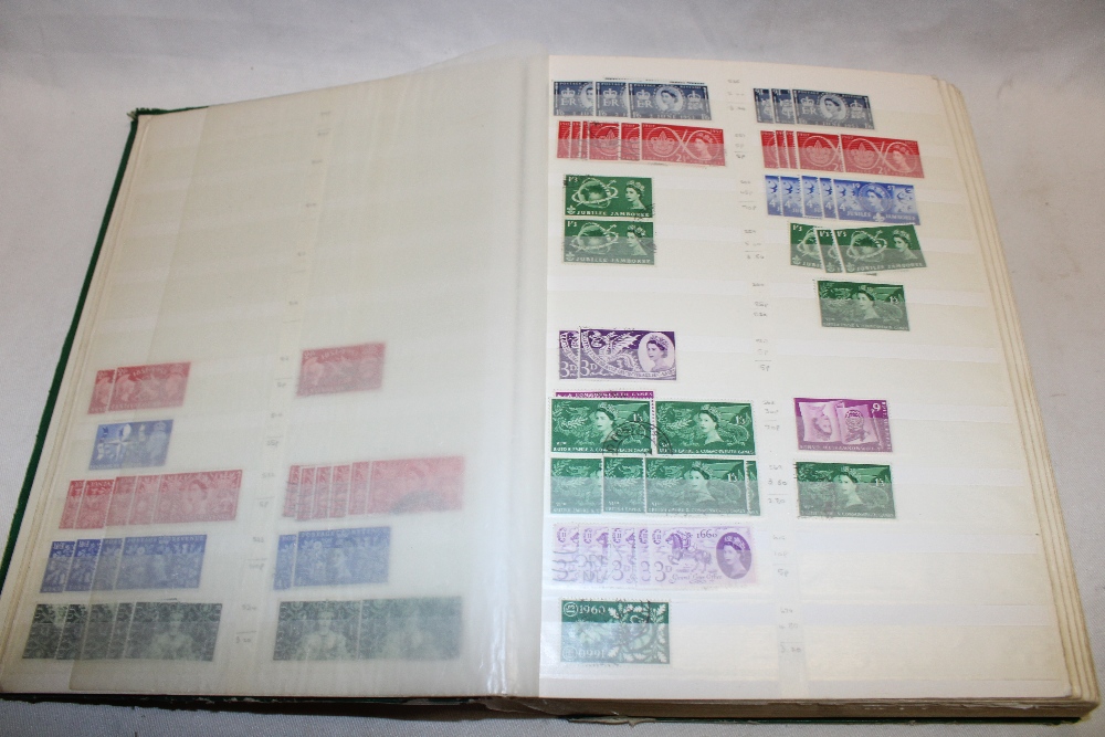 A large stock book containing a selection of EIIR mint and used commemorative stamps